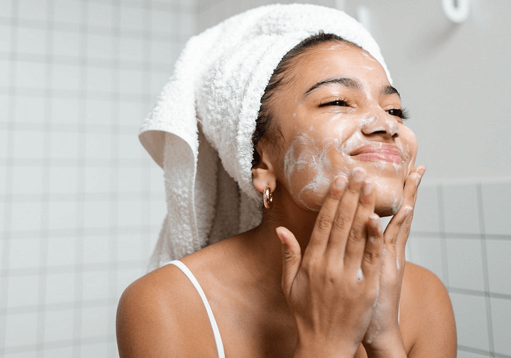 Woman cleansing dry skin